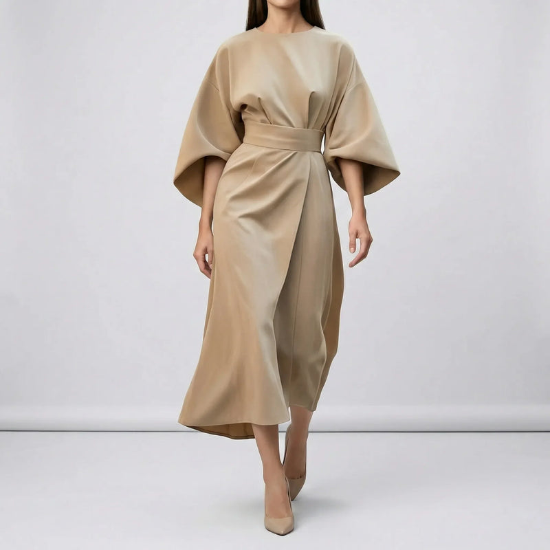 Beige dress worn by a model on a white background