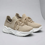 Beige sneakers with white soles on a gray background1