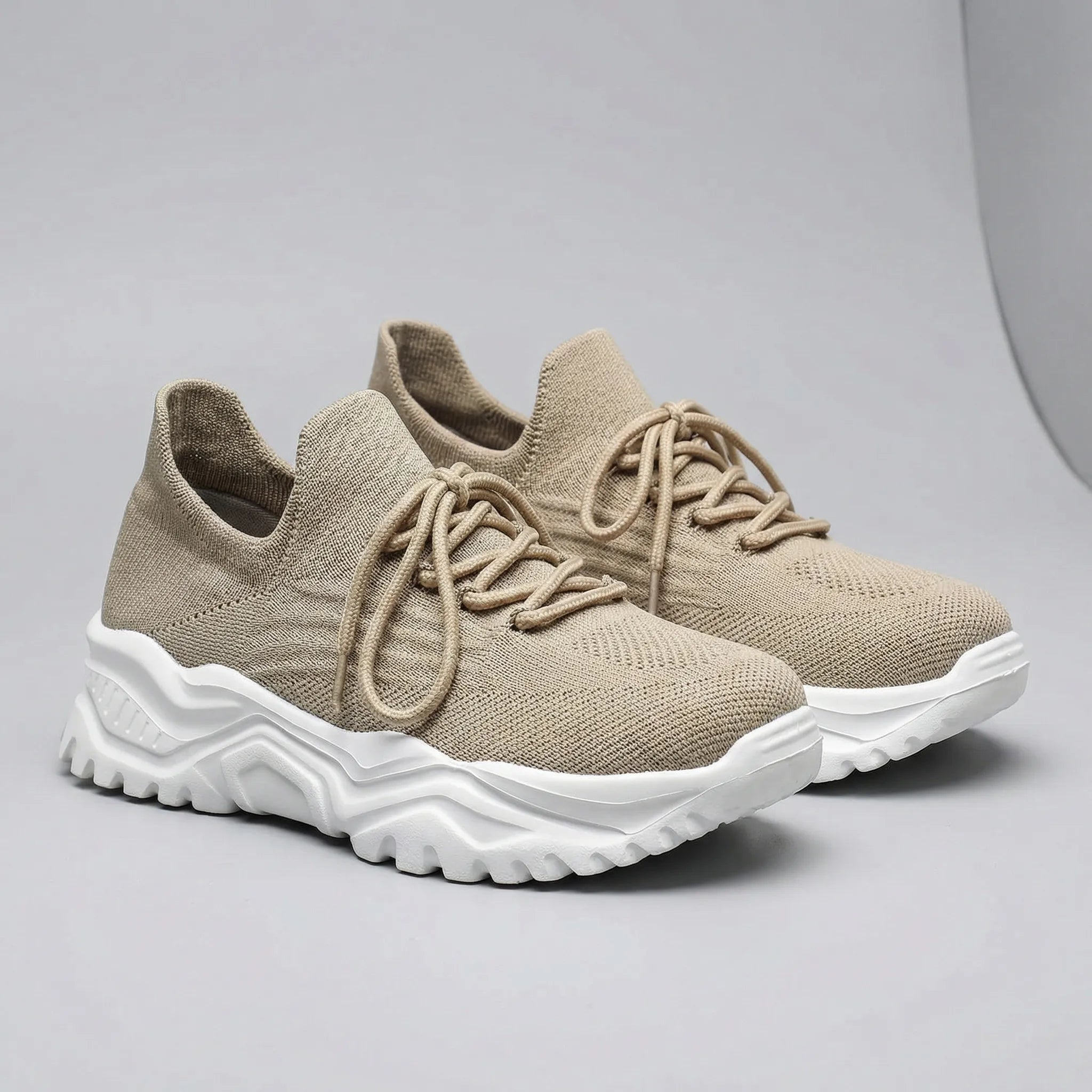 Beige sneakers with white soles on a gray background1