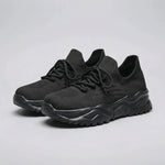 Black running shoes on a white background
