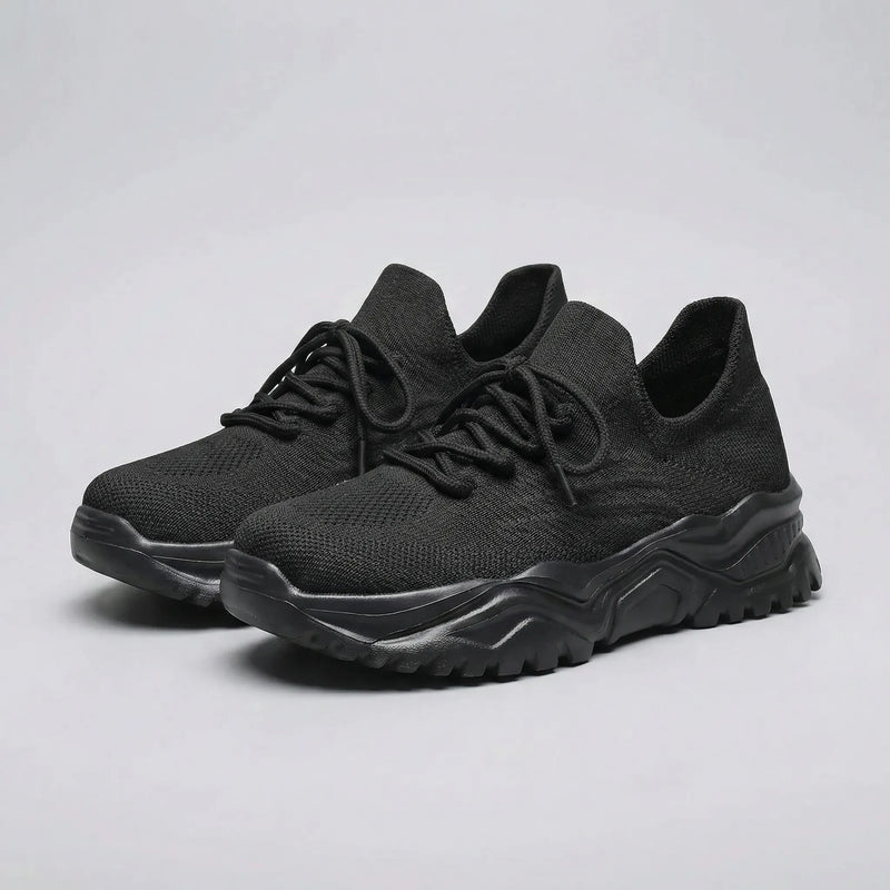 Black running shoes on a white background