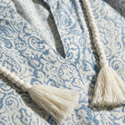 Close-up of a blue and white patterned fabric with tassels.2