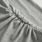 Close-up of dark gray fabric with a focus on texture and stitching2