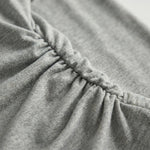 Close-up of dark gray fabric with a focus on texture and stitching2