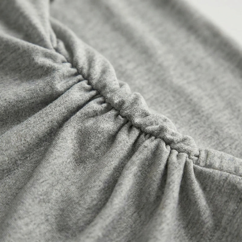 Close-up of dark gray fabric with a focus on texture and stitching2