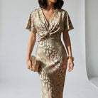 Women’s midi cocktail dress with V-neckline, knot-detail waist and flutter sleeves for weddings and summer occasions.1