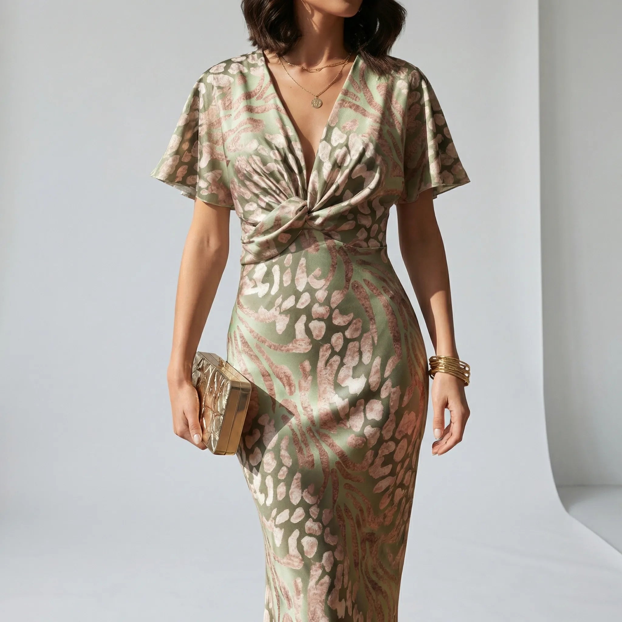 Women’s midi cocktail dress with V-neckline, knot-detail waist and flutter sleeves for weddings and summer occasions.1