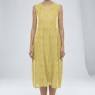 Light Yellow dress with floral patterns on a white background
