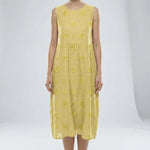Light Yellow dress with floral patterns on a white background