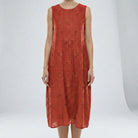 Red sleeveless dress with floral patterns on a white background