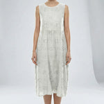 White sleeveless dress with floral patterns on a plain background