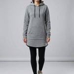 Person wearing a gray hoodie and black leggings on a plain background4
