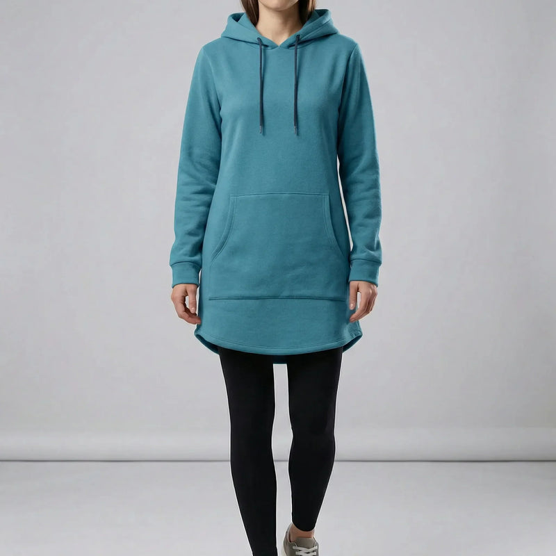 Person wearing a teal hoodie and black leggings on a plain background