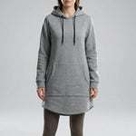 Person wearing a gray hoodie dress on a plain background1
