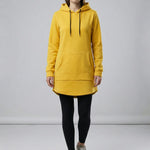 Person wearing a yellow hoodie and black leggings on a plain background 