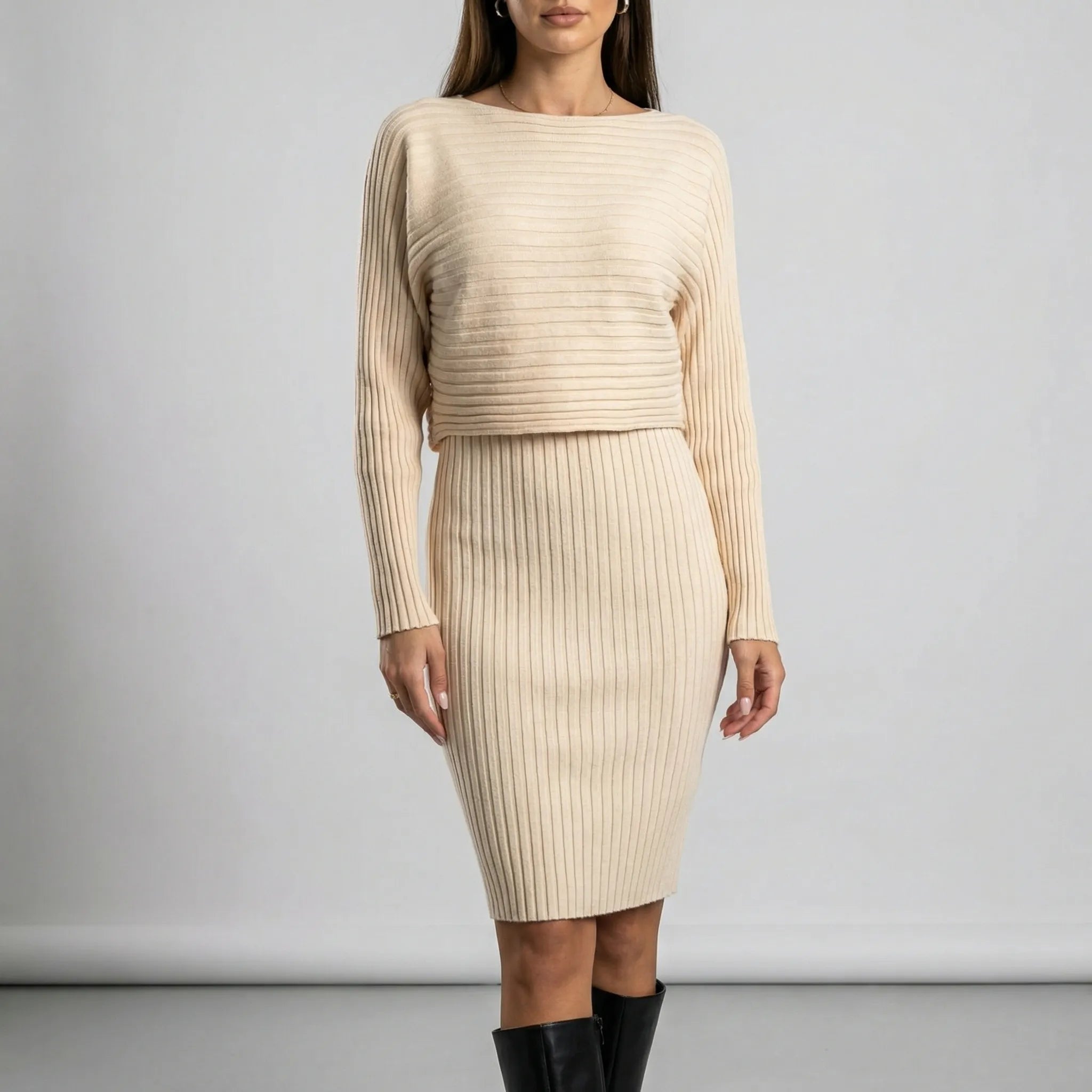 Woman wearing a beige ribbed dress with long sleeves against a plain background2