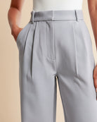 Light gray pleated pants on a beige background