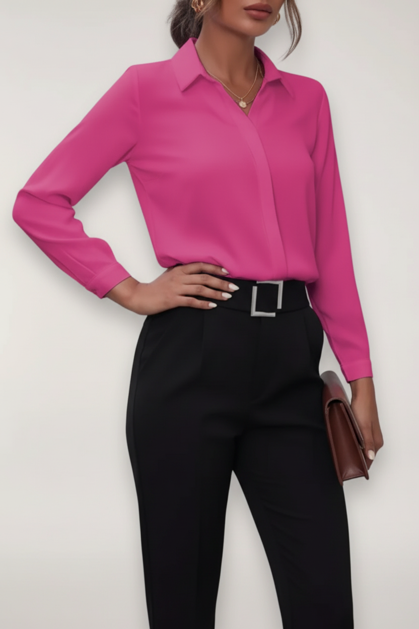 Person wearing a bright pink shirt and black pants against a white background