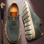 Green sneakers with brown accents on a dark surface