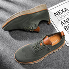 Green casual shoes with brown accents on a gray surface