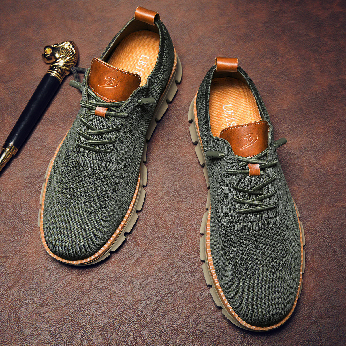Green sneakers with brown accents on a textured brown surface