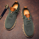 Green sneakers with brown accents on a textured brown surface