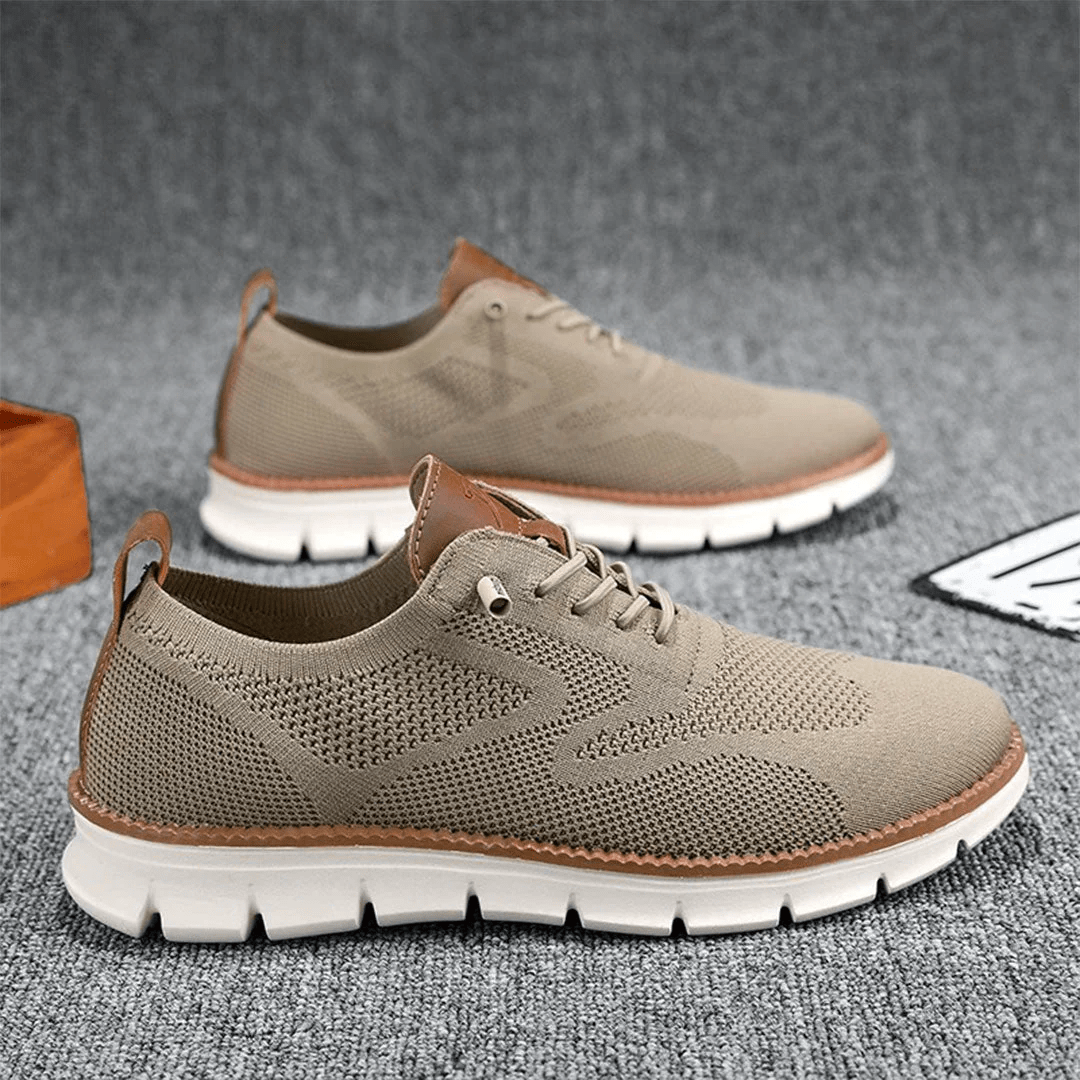 Pair of brown casual shoes on a textured gray surface