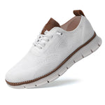 White sneaker with brown accents on a white background