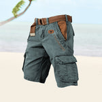 Green cargo shorts with a brown belt on a light background