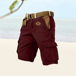 Brown cargo shorts with a belt on a light background