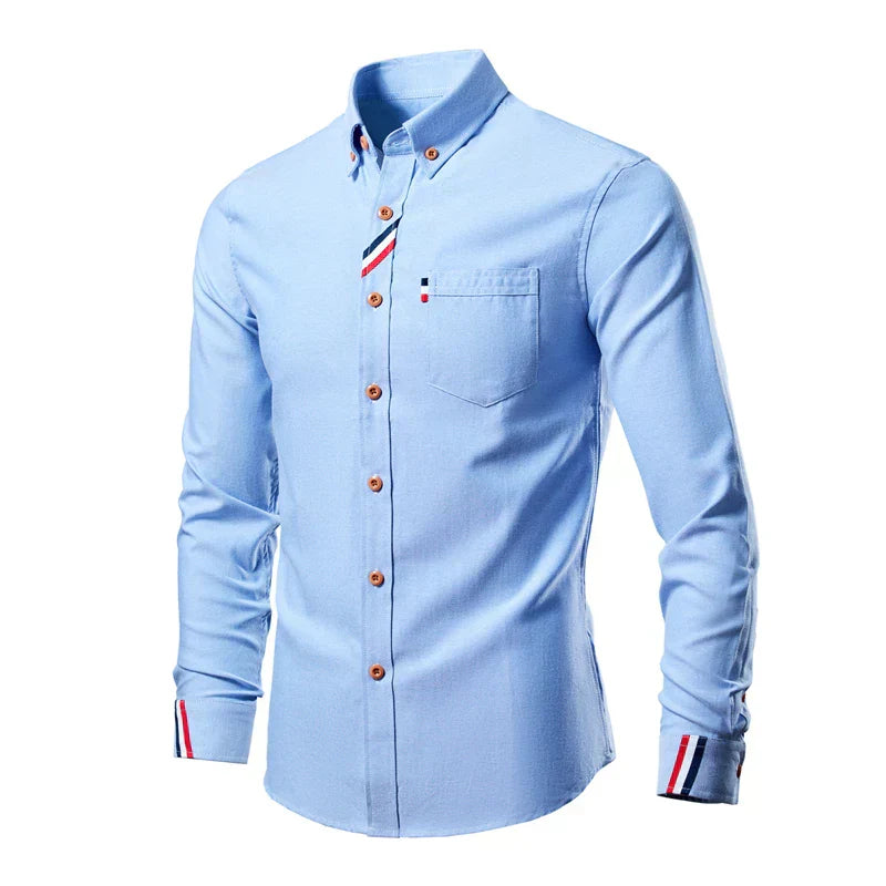Light blue shirt with decorative buttons and trim on a white background
