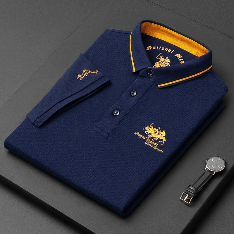 Folded navy blue polo shirt with yellow accents and branding on a dark surface.