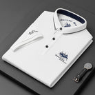 White polo shirt with brand logos on a dark surface, accompanied by a watch.