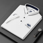 White polo shirt with brand logos on a dark surface, accompanied by a watch.