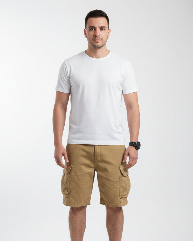 Person wearing beige cargo shorts with a blurred background