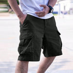 Person wearing olive green cargo shorts with a blurred background