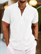 Man wearing a white short-sleeve shirt with a blurred background