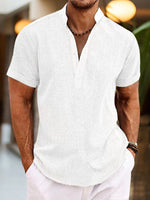Man wearing a white short-sleeve shirt with a blurred background