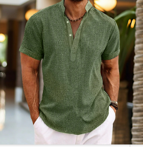 Man wearing a green patterned shirt and white pants in an outdoor setting