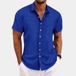 Man wearing a blue short-sleeve shirt on a white background