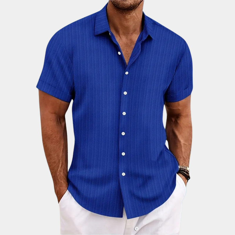 Man wearing a blue short-sleeve shirt on a white background