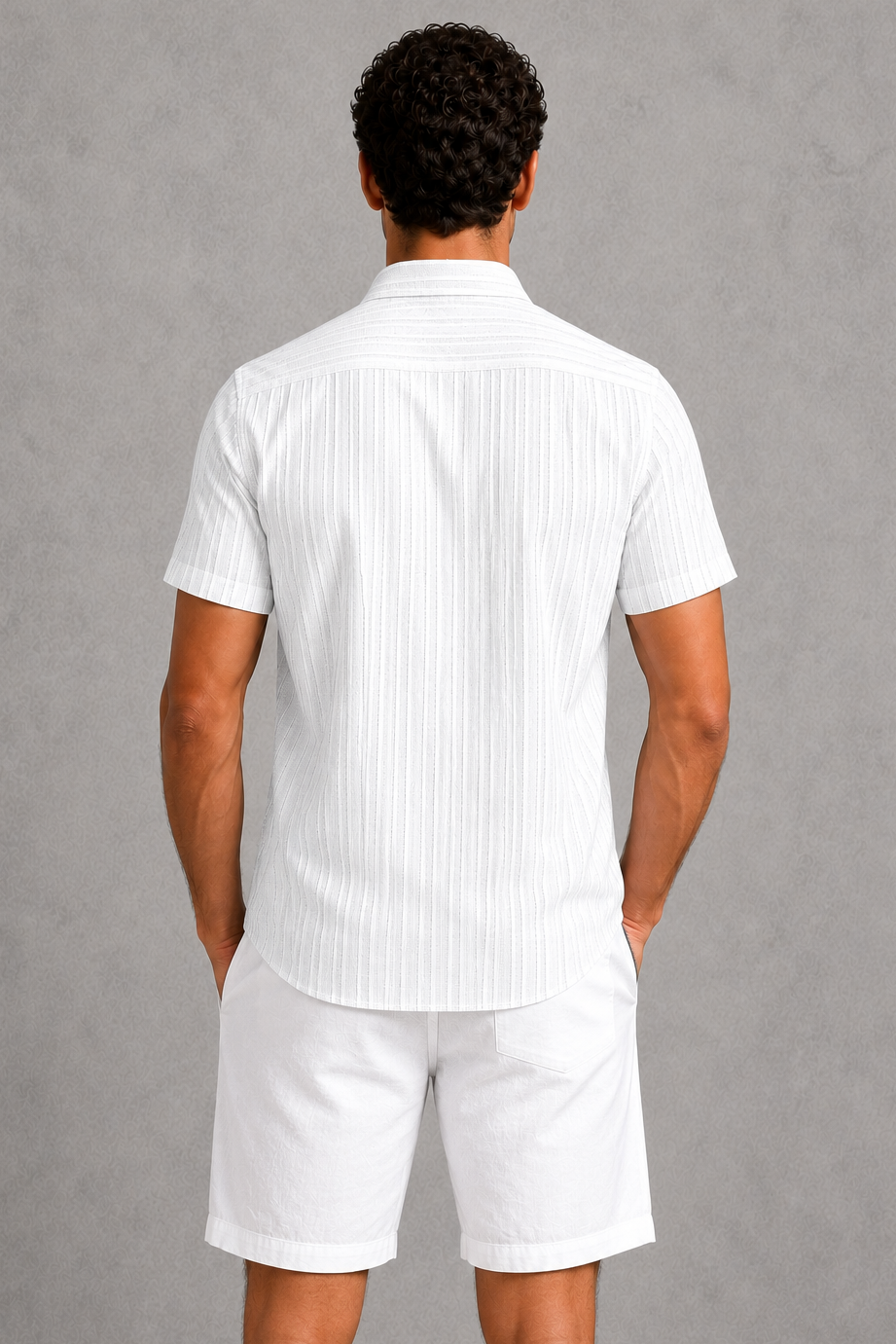 Person wearing a white striped shirt and shorts against a gray background