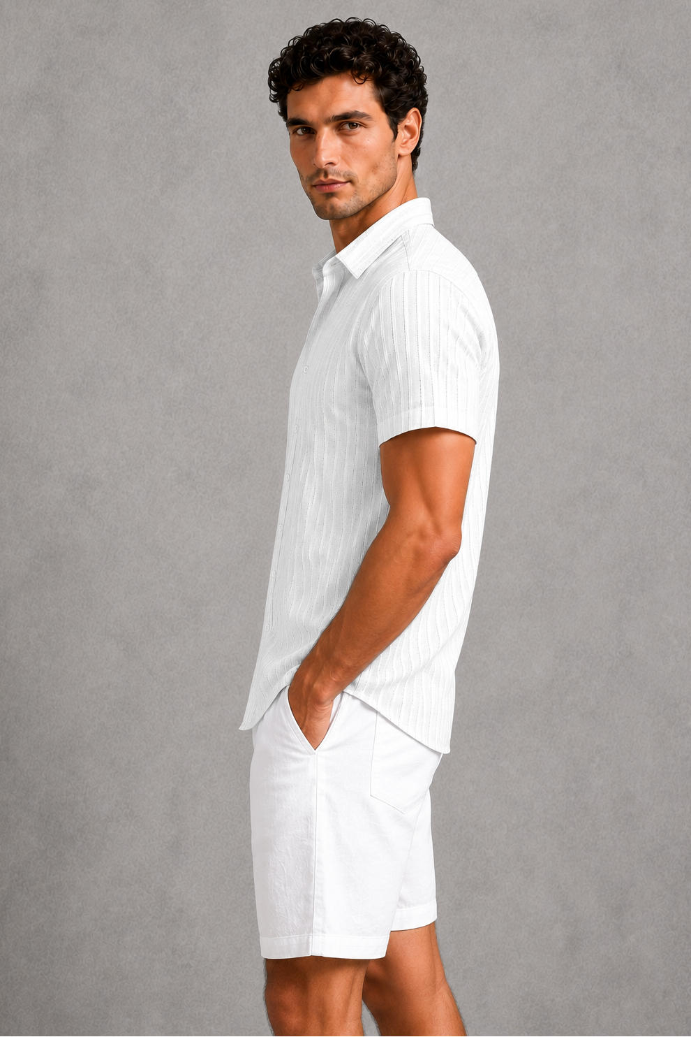 Man wearing a white dress shirt and shorts against a gray background