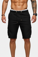 Black cargo shorts worn by a person on a white background