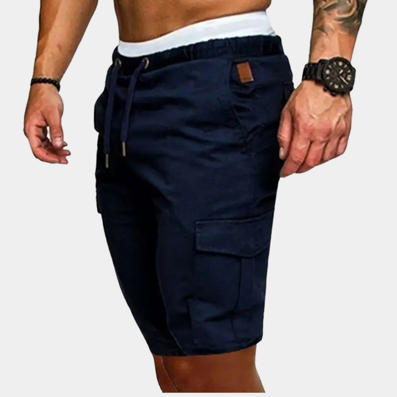 Navy cargo shorts worn by a person on a light gray background