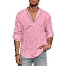 Man wearing a pink long-sleeve shirt and gray pants on a white background