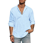 Man wearing a light blue shirt with rolled-up sleeves on a white background