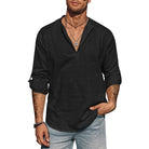 Man wearing a black long-sleeve shirt with rolled-up sleeves on a white background