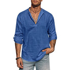 Man wearing a blue long-sleeve shirt and gray pants on a white background