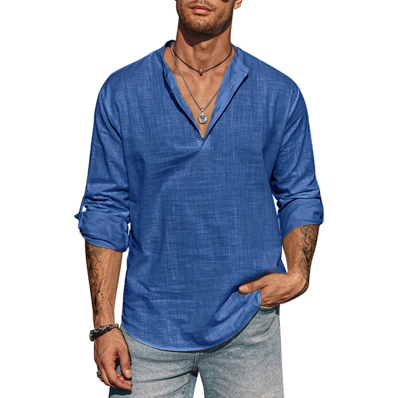 Man wearing a blue long-sleeve shirt and gray pants on a white background
